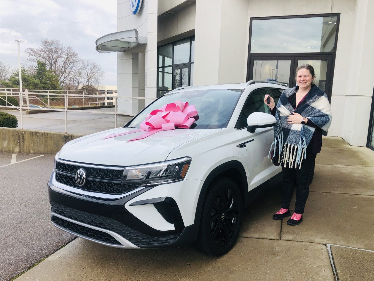 A happy customer with her new SUV at our dealership in Dayton, OH