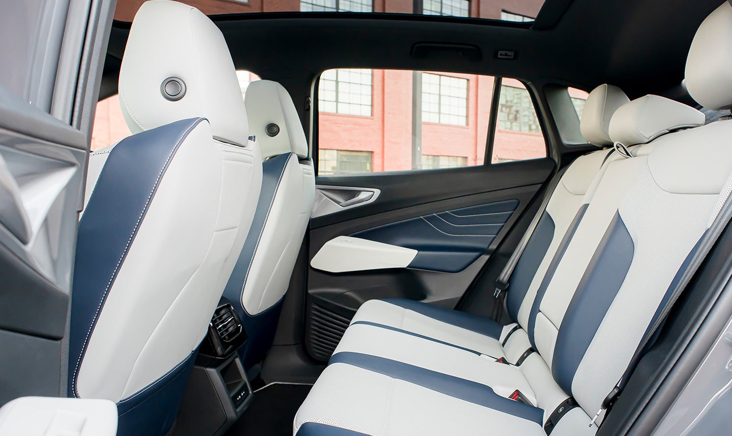 A close-up shot looking in at the rear seating area of an ID.4 shown in Cosmic interior with a focus on the passenger space and seating surfaces.