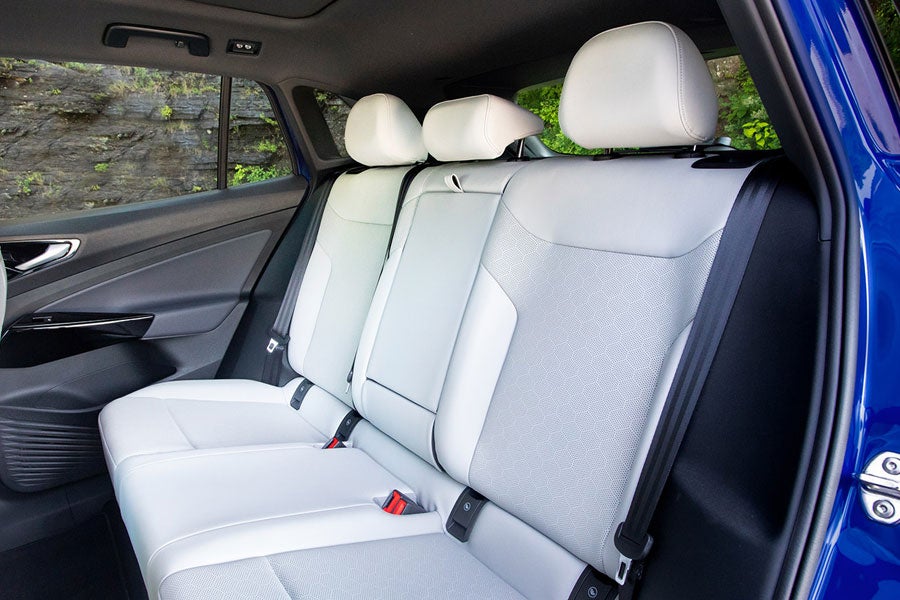 A parked ID.4 in Dusk Blue Metallic, with focus on the rear seating.